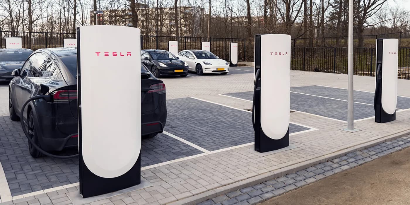 Tesla vehicles charging in a business parking lot